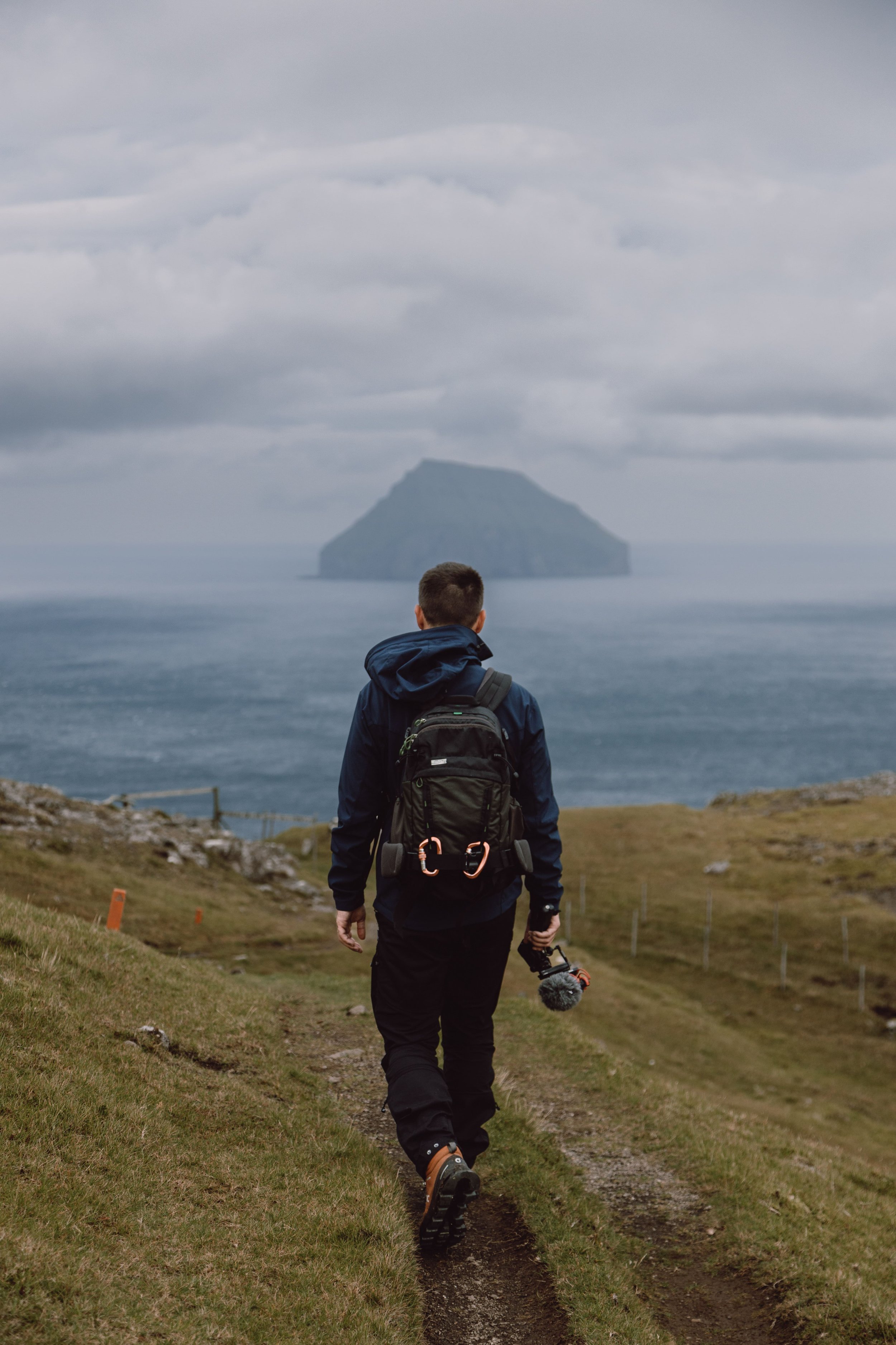 man walking around Hvannhagi hike in Suduroy
