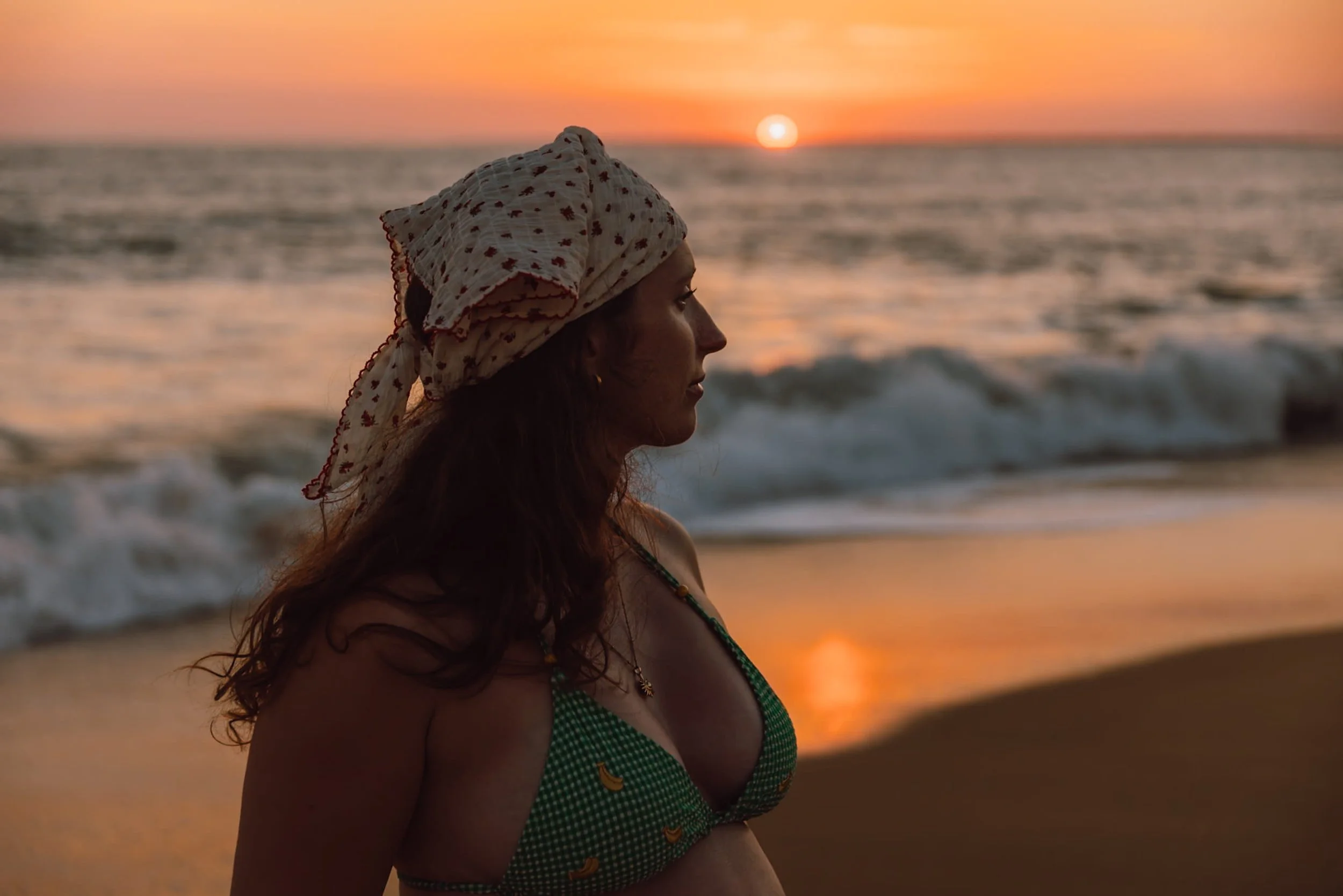 woman watching the sunset on Plage de la Terriere