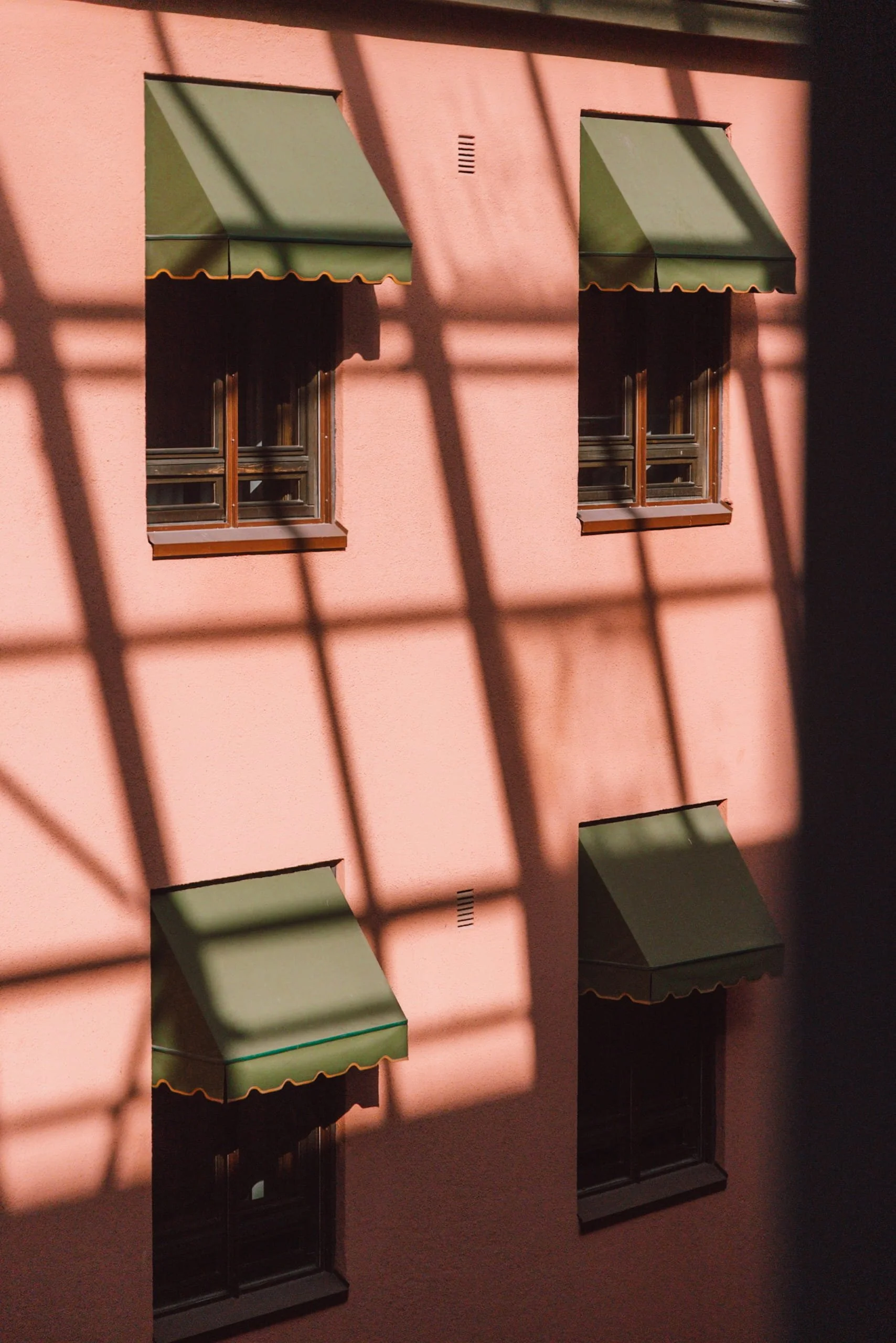pink walls for Hotel Verso with green shutter blinds