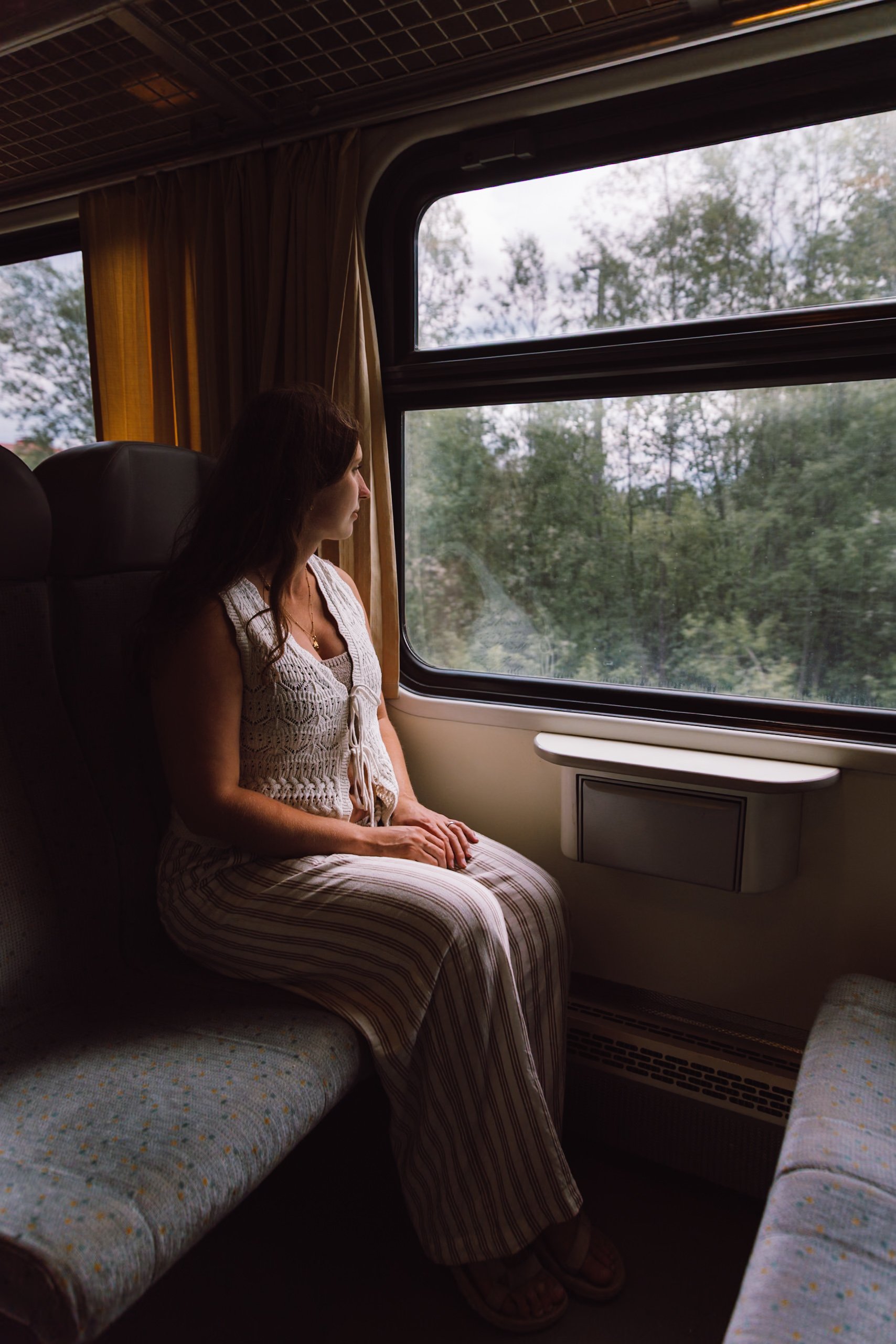 woman sat on train in Jyväskylä looking out the window