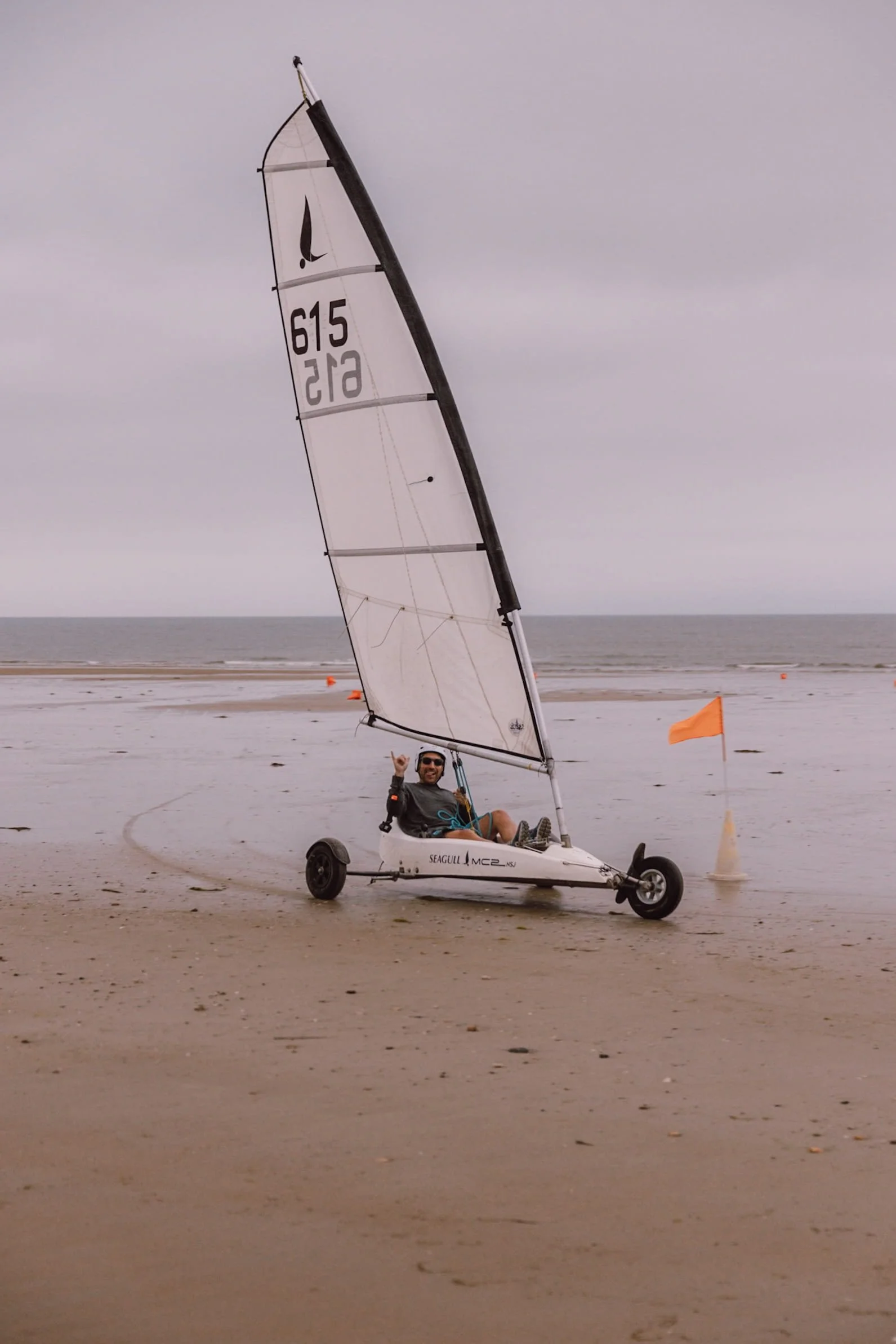 man driving sand yacht on the beach