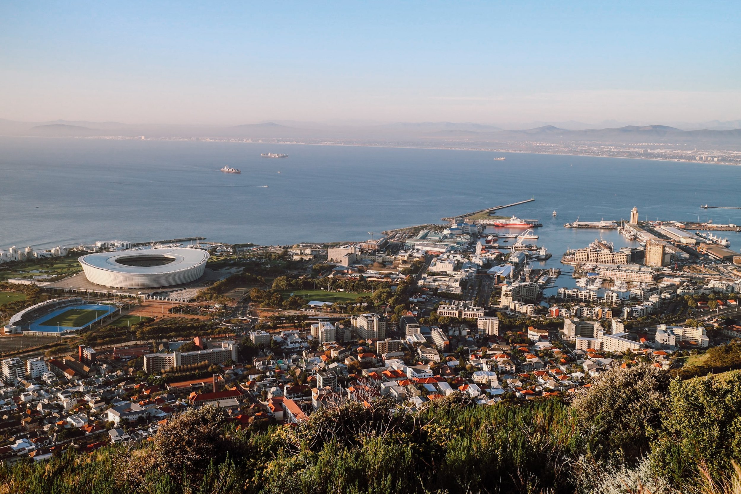 view of the waterfront from lions head with ocean and at sunset