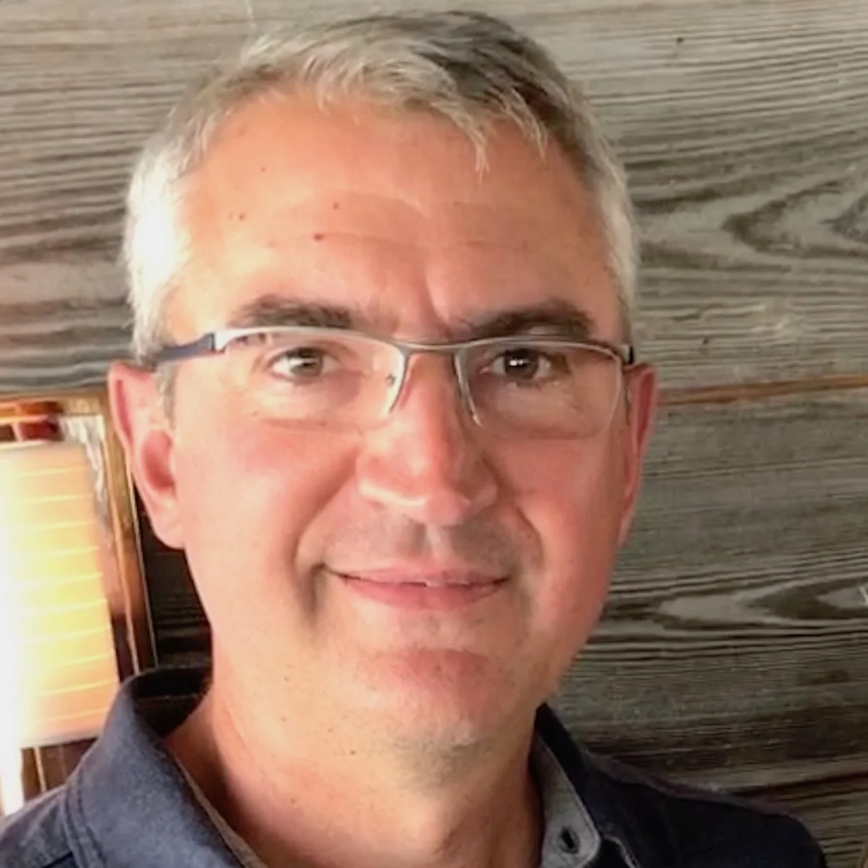 Will Burns standing in front of wood paneled walls on Nantucket.
