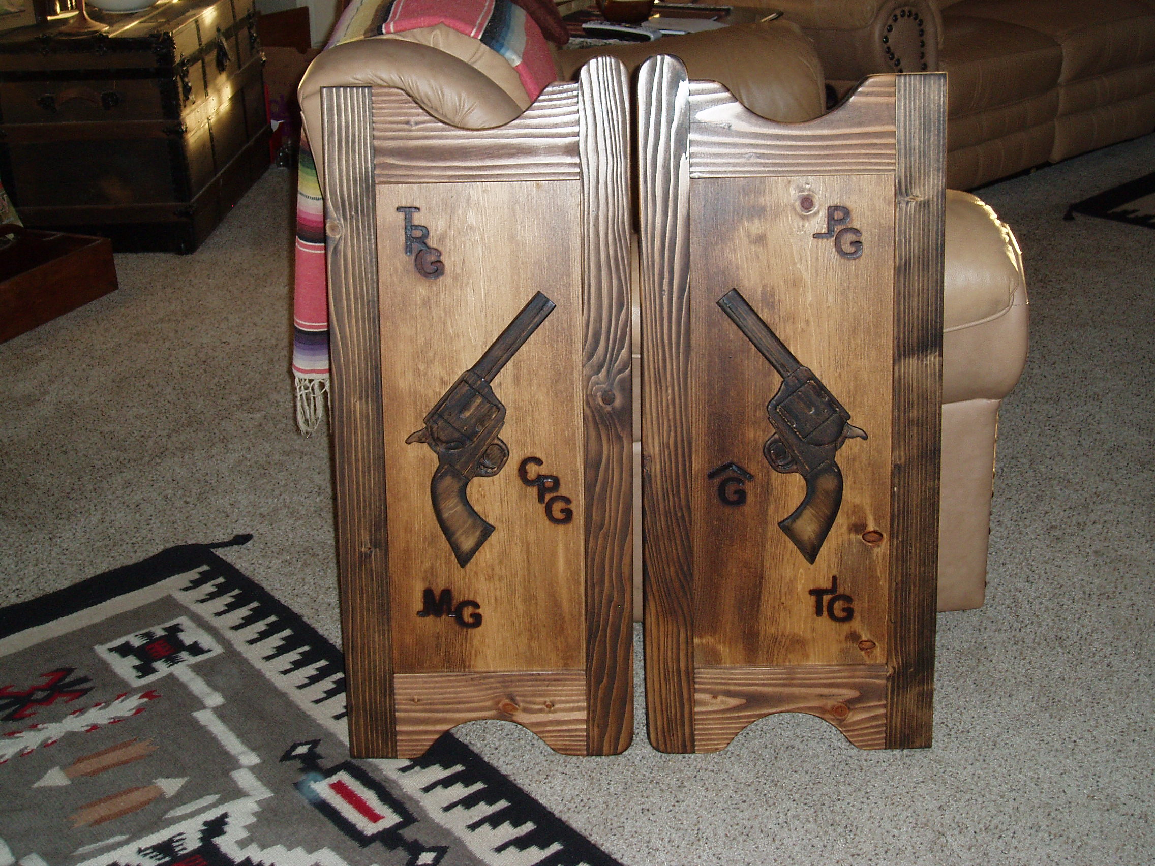 Western saloon doors with pistols and cattle brands