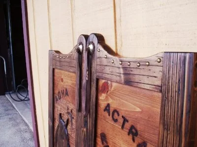 Western saloon doors with leather rosette, concho and straps with blood knot, brass bottoms