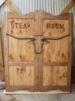 Steak room oversize western saloon doors with Texas longhorn