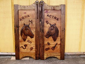 Western saloon doors with horses and cattle brands