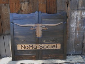 NoMa Social House western saloon door with dark stain and Texas longhorn