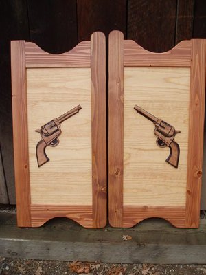 Western saloon doors with six shooter pistols