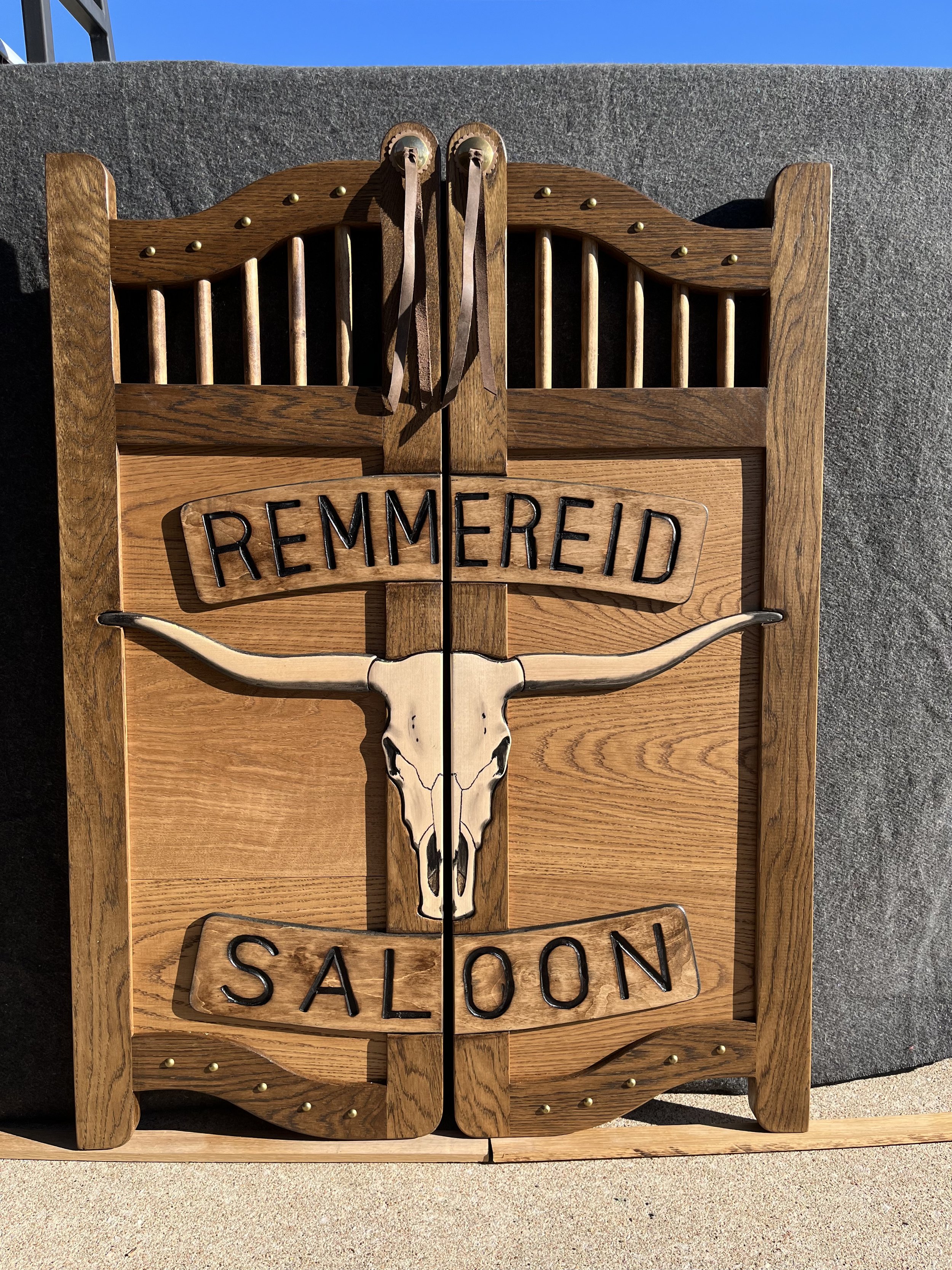 Western saloon door with texas longhorn skull.jpeg