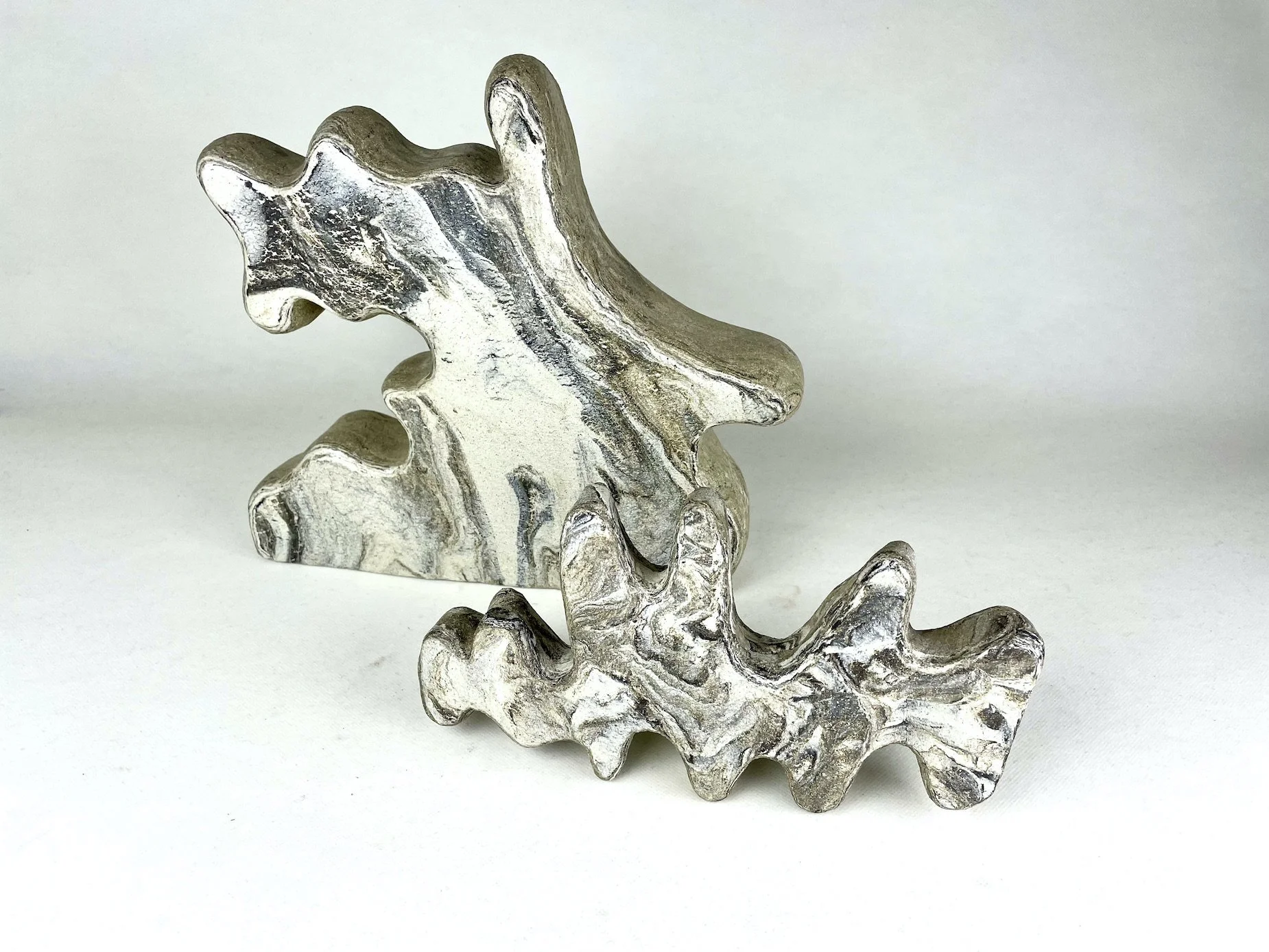   Held in Passing   2025, 28cm H, blended clays - white raku and dark matter 