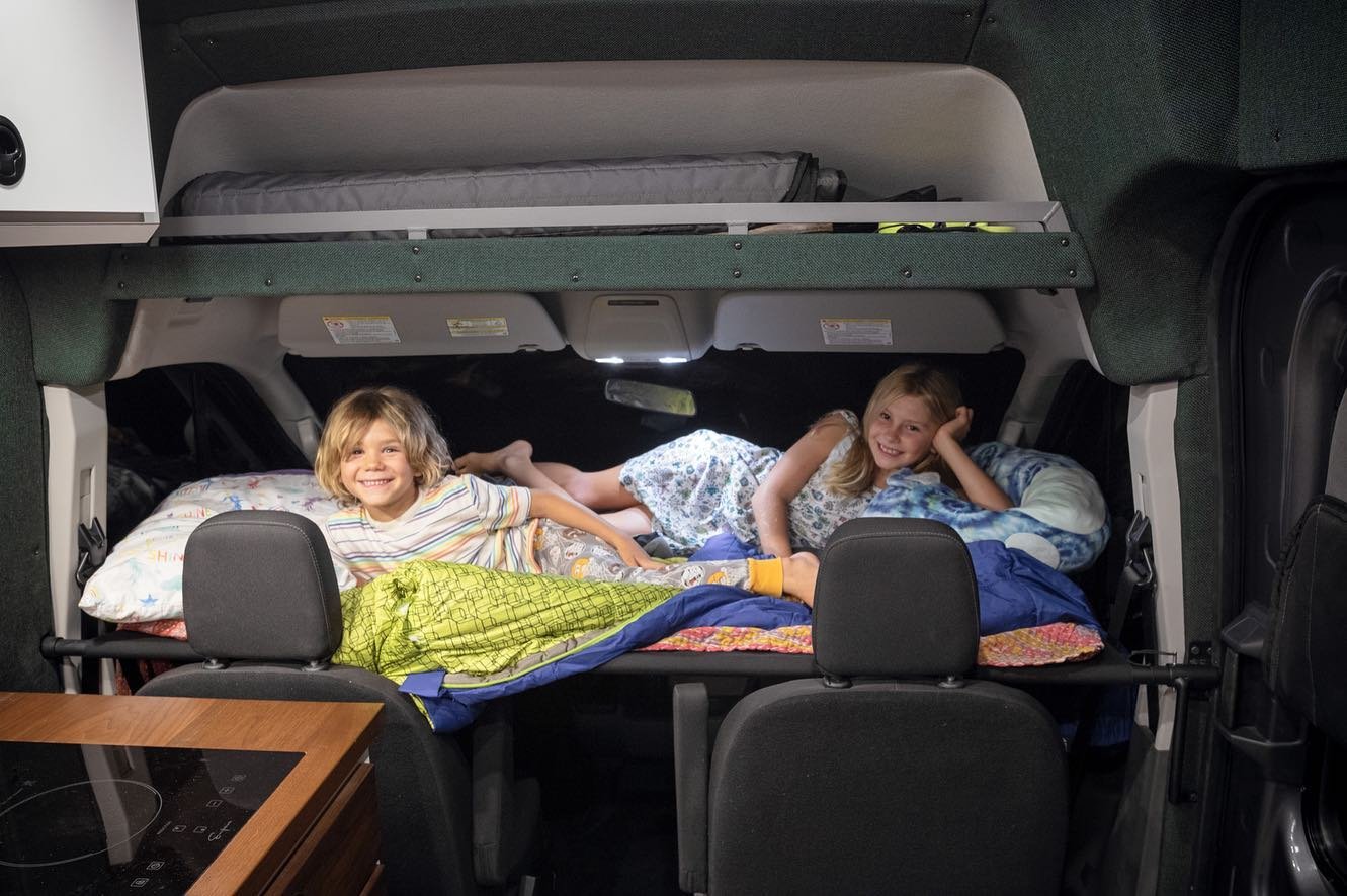 This Ford Transit campervan just got more room inside now that the kids have a place to hang out . . . out of your way. 
👏💪

The Kids Kot essentially makes the space inside your van bigger by utilizing the often un-used awkward area above the front