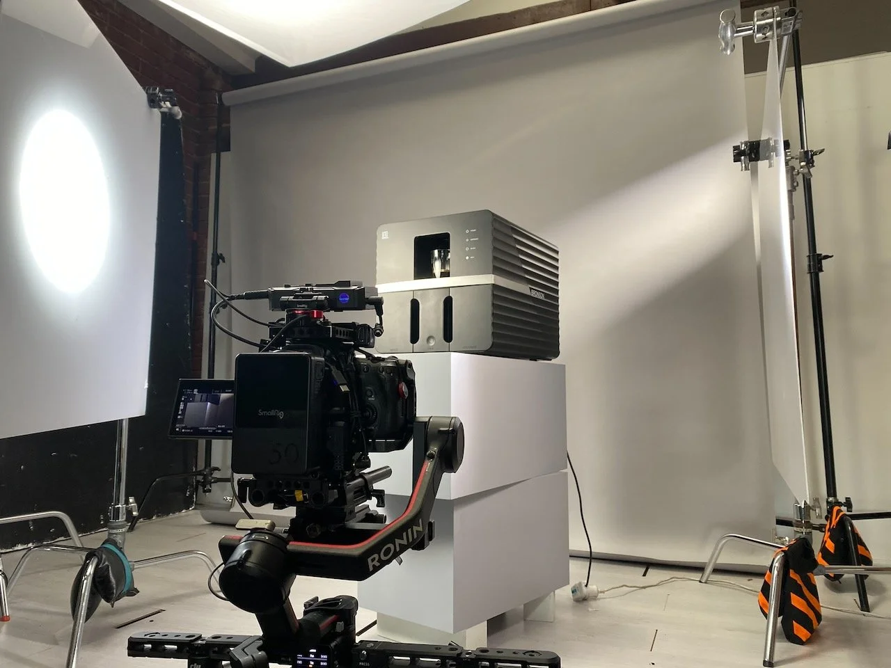 Photography and videography  setup with a camera on a stabilizer, behind the scenes product photo and video shoot.