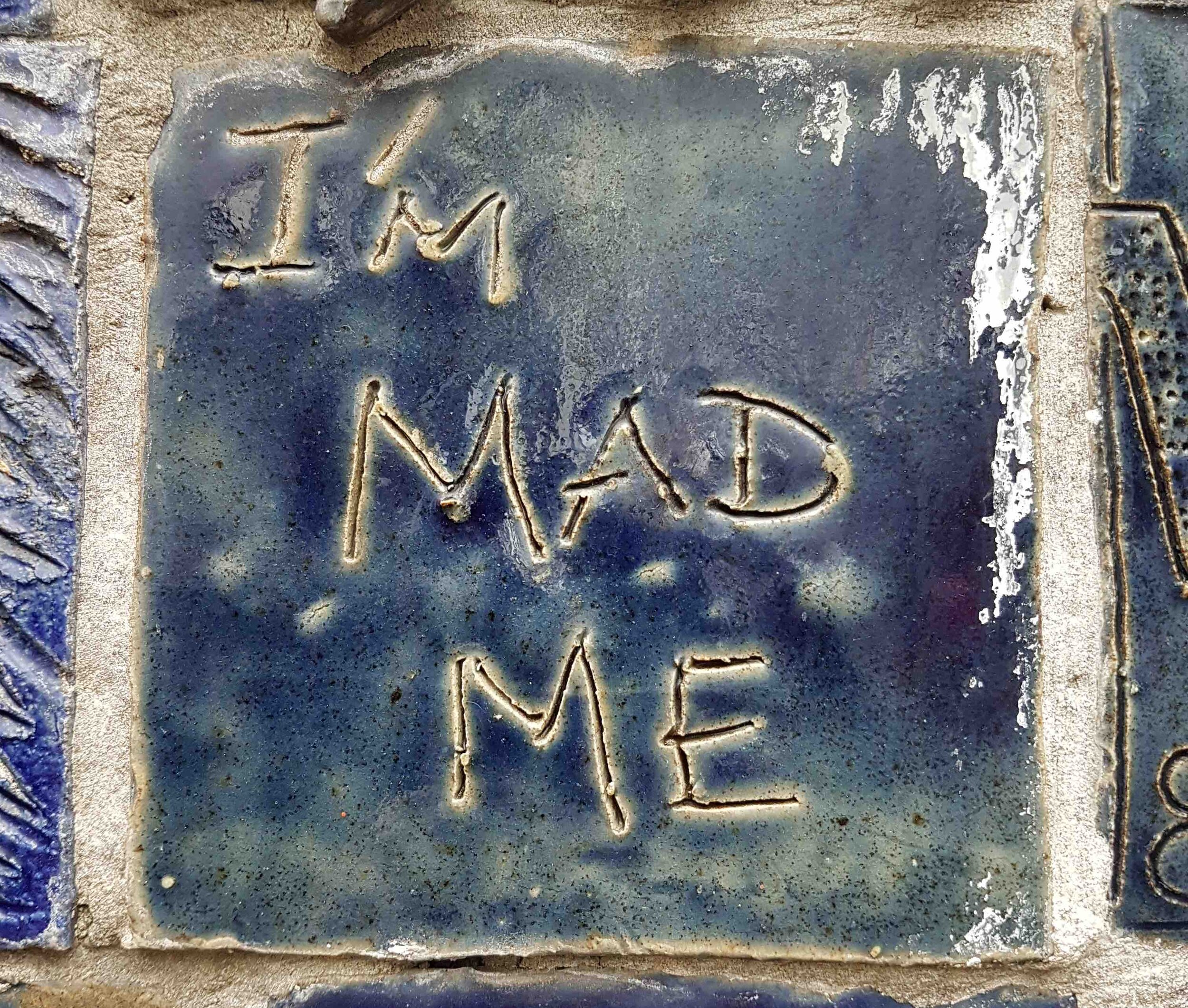 Image of Street Art with I'm Mad Me quote scrated into surface.jpg