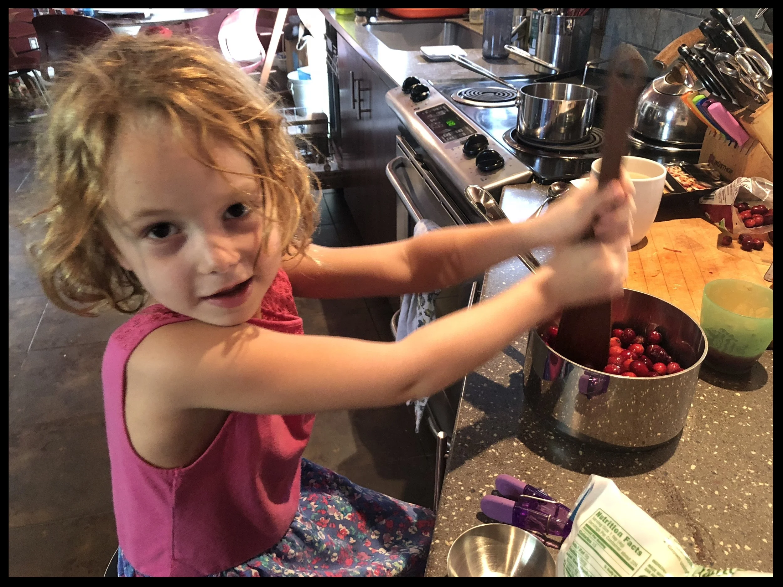 My youngest “hard at work” on the cranberry sauce last year. This is a super easy recipe. The “hardest” part is deseeding the pomegranate. Fun job for kids.