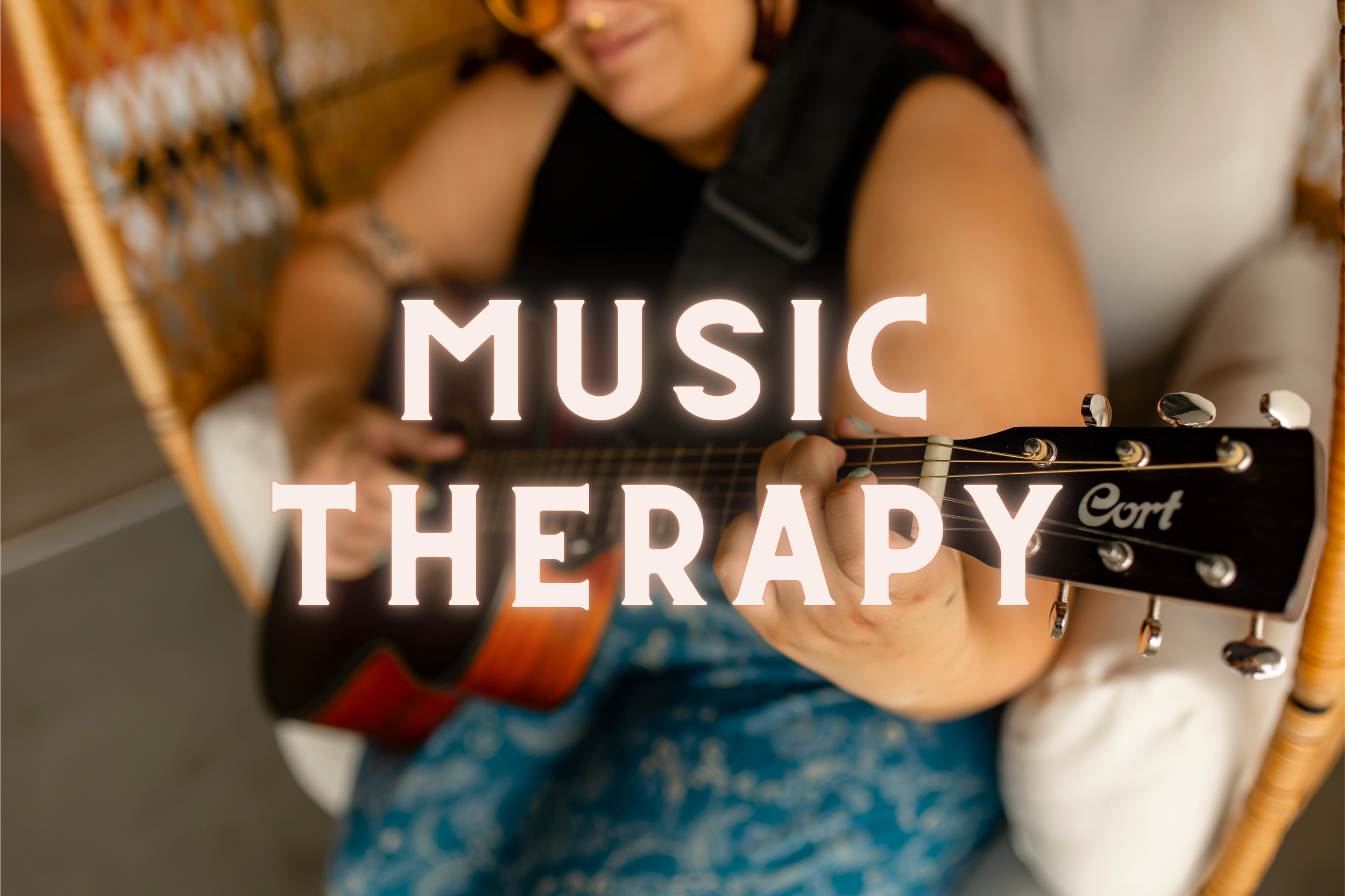 a music therapist in Ferndale, Michigan sits down with a client and her guitar for a session