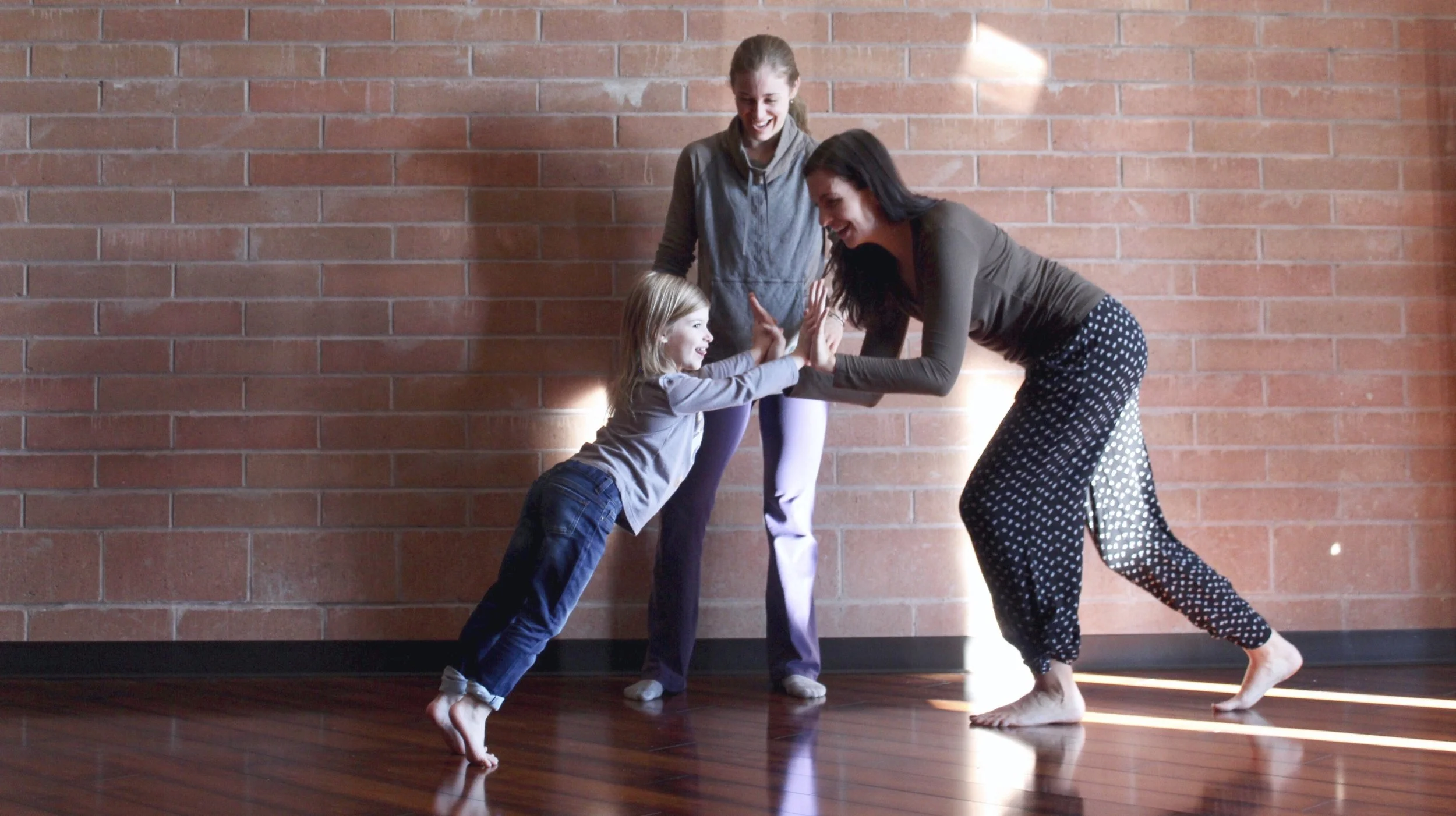 a dance therapist uses a push pull technique to help a child find their footing and strength from the ground