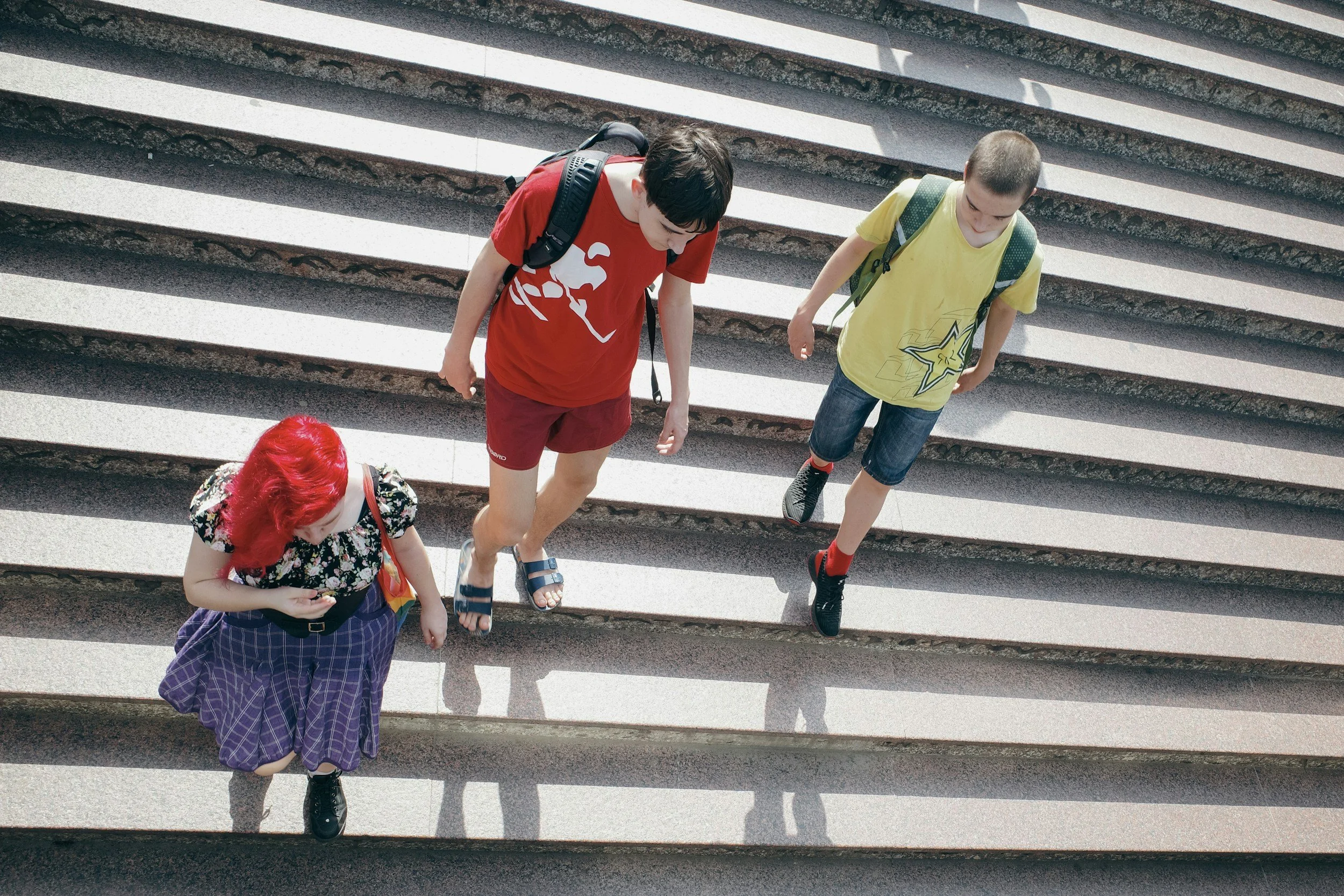 three teenagers walk the stairs of their school in between classes. a reminder that transitions can be the hardest part of the day and a good place for parents to check in