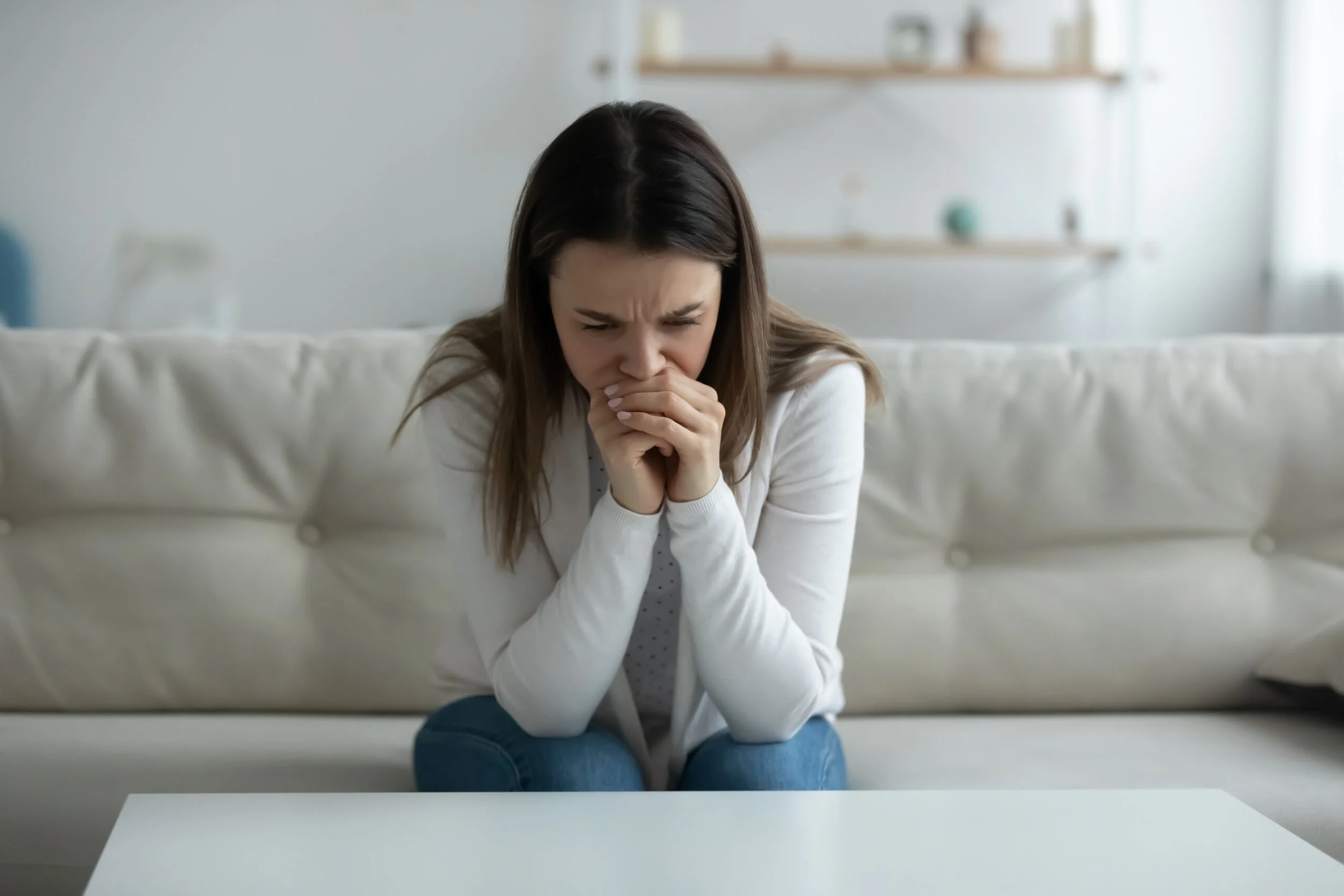 woman sitting down looking worried. Begin your healing journey for anxiety and depression in Ferndale, Royal Oak, and Detroit | 48220 |  48067 | 48228