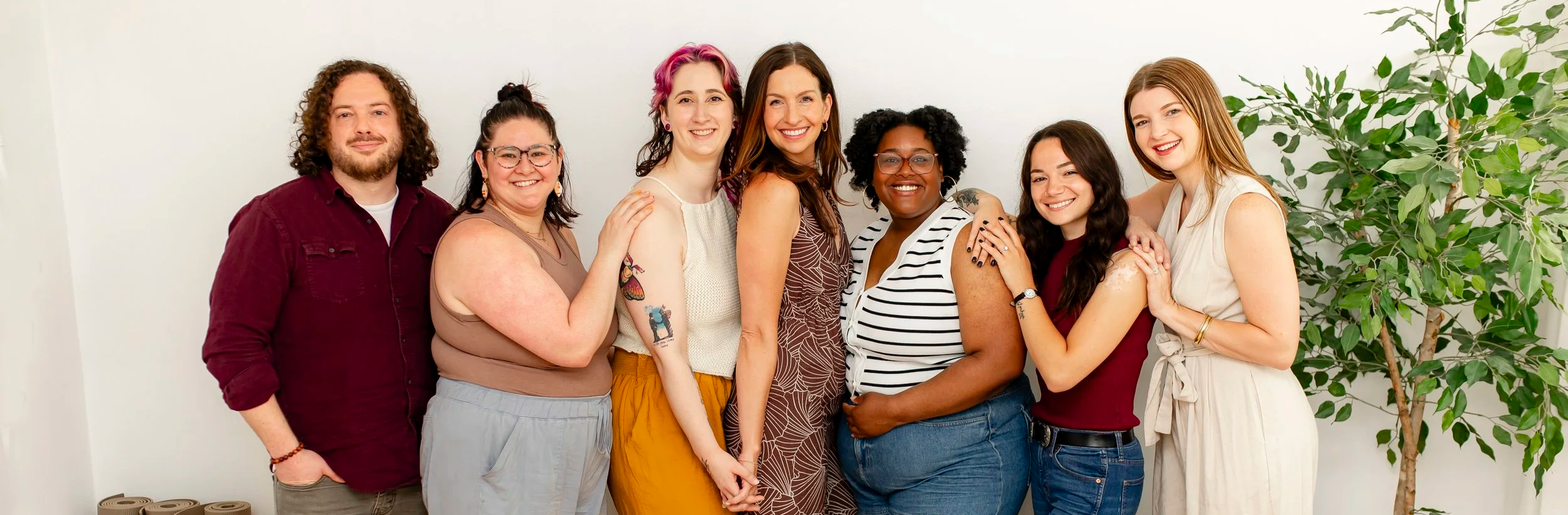 the team of Inspired Healing Therapy, connected and gazing toward the audience