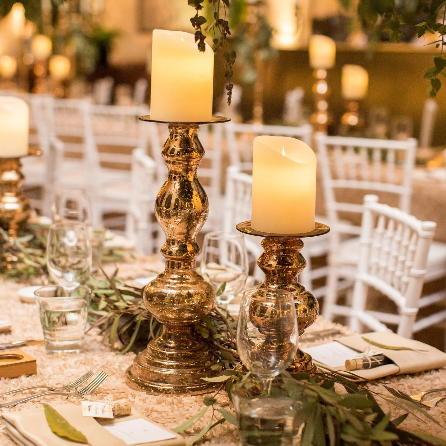 Columbine and Damien - Champagne Heather luxury linen, champagne napkins, gold Stefania candlesticks with LED pillar candles, white Tiffany chairs.jpg