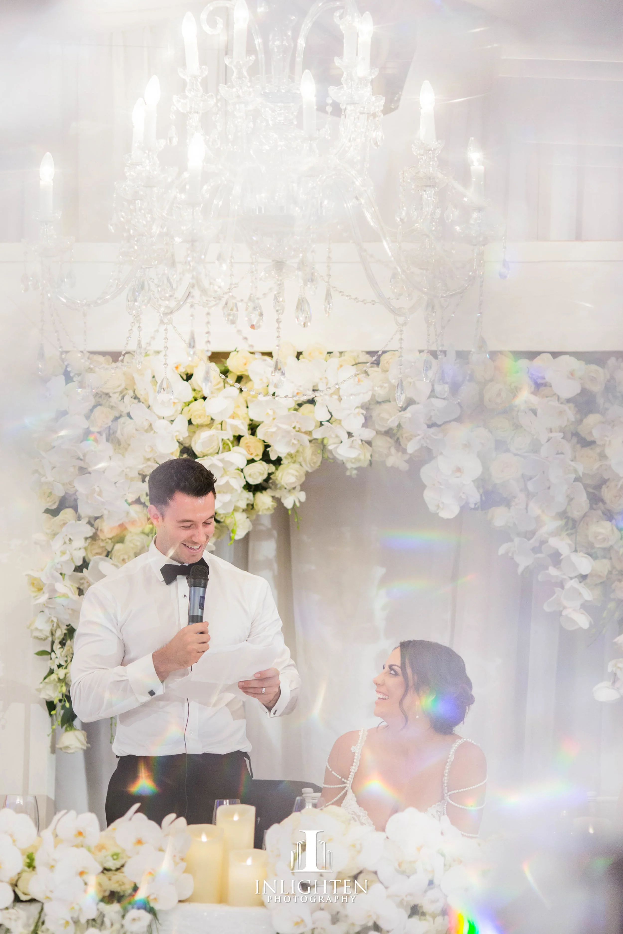24 Kayla & Joe - Opera Point Marquee_Bridal table long_low custom built frames_fresh flowers_LED pillar candles_Sofia chandelier.jpg