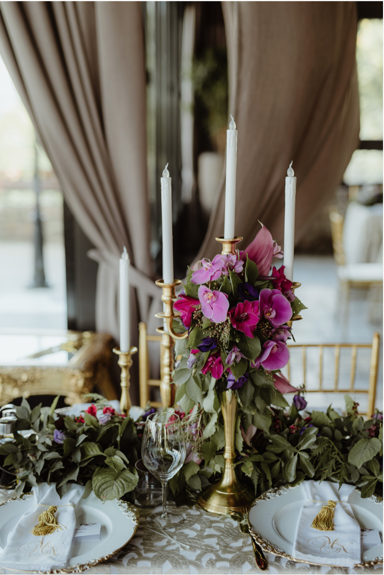 gold_candleabra_LED_candles_purple_floers_centrepieces_charger_plates.png
