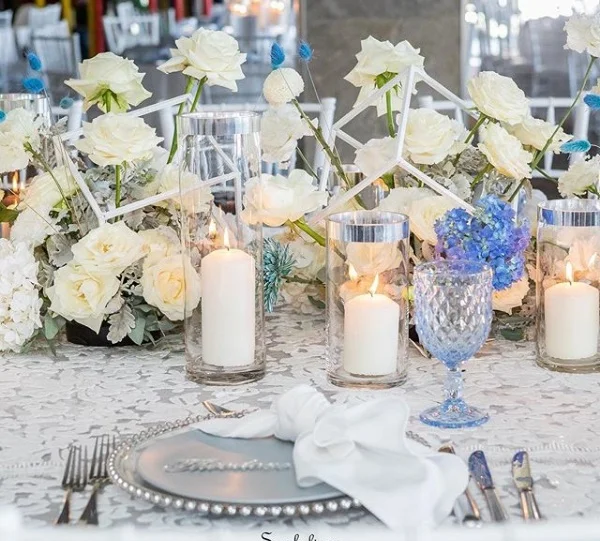 White_anita_blue_underlay_silver_charger_plate_blue_theme_candles_white_flowers.png