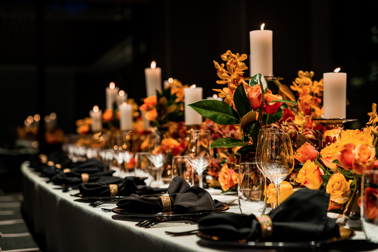 corporate_event_design_events_by_nadia_fresh_flowers_orange_black_charger_plate_candle_stick_gold_napkin_ring.png
