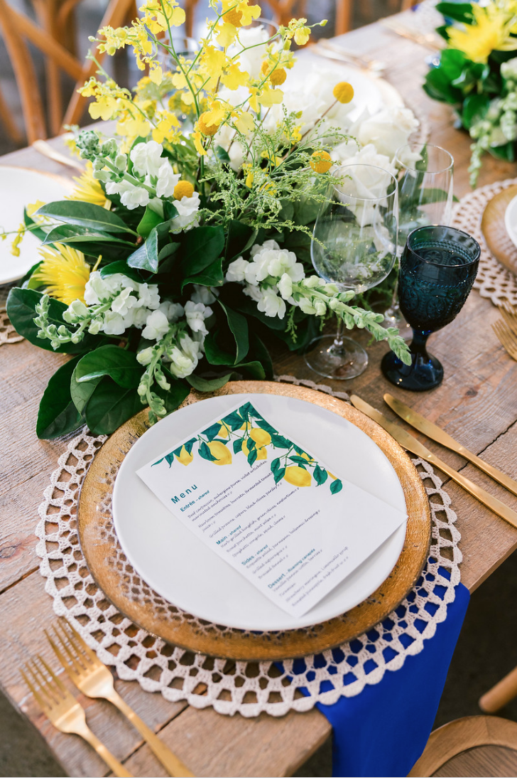 Special_event_activation_event_decor_event activation_positano_theme_menu_yellow_blue_gold_charger_plate_gold_cutlery.png