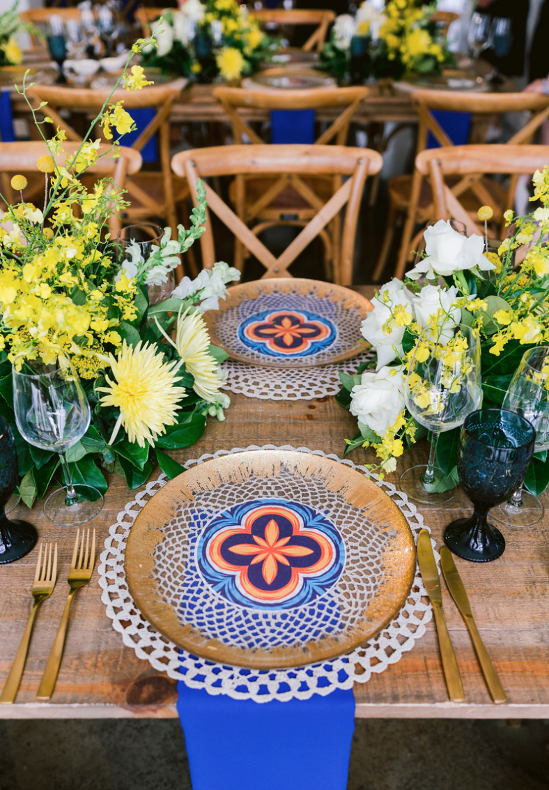Special_event_activation_event_decor_event activation_positano_theme_tile_gold_charger_plates_blue_napkin_gold_cutlery_yellow_flowers.png
