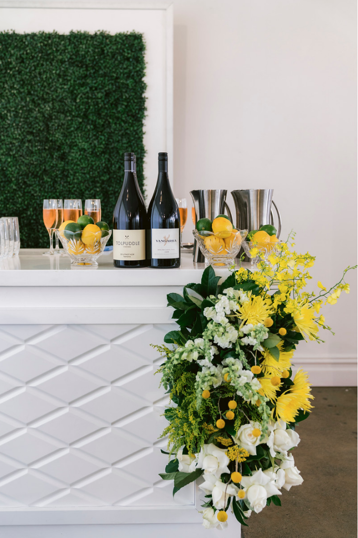 Special_event_activation_event_decor_event activation_positano_theme_yellow_white_flowers_bar_wine.png