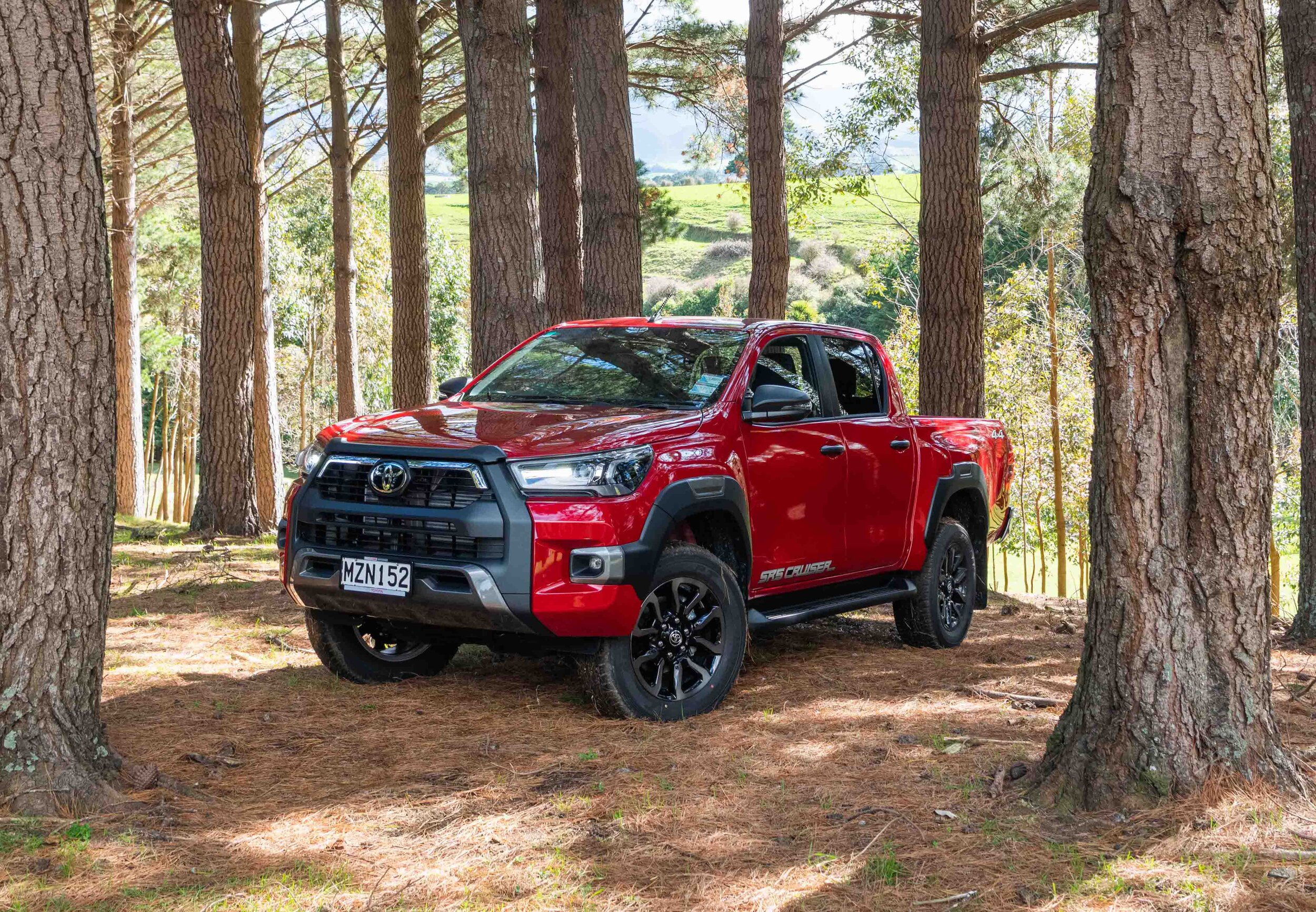 IMAGE_2021 Toyota Hilux SR5 Cruiser grade 4WD double cab, emotional red, front three quarter forest shot .jpg