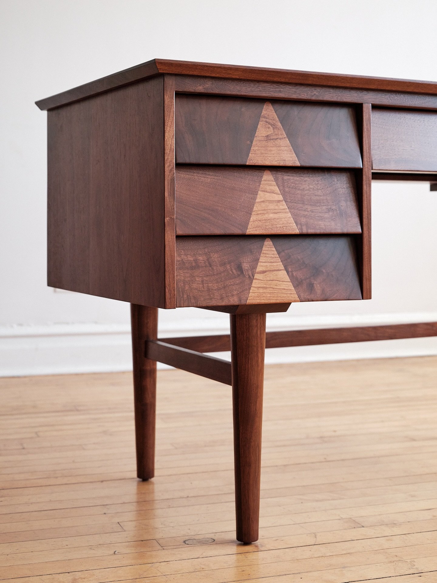 Our Monty desk available in 46&rdquo; wide (seen here) or 60&rdquo; wide. Triangle inlays contrasting two different wood species give it a fun character detail. This design by Kayla comes from our early days of picking vintage furniture and coming ac