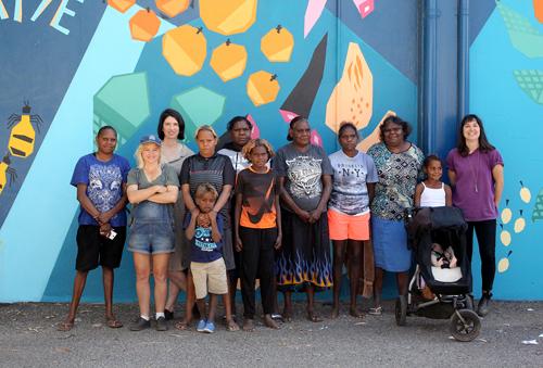 Hidden Valley Artists, Province’s Al Dadak, WTS Coordinator Alex Hullah and Tangentyere Artist Manager Jo Byrne pose in front of the Ewyenper Atwatye Mural, 2015