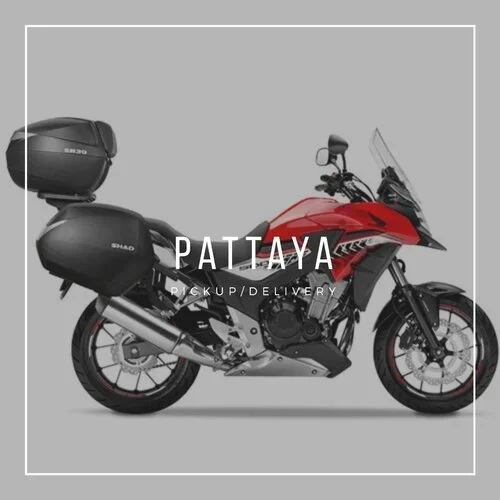 Red CB500X, side view, with Pattaya printed over the image