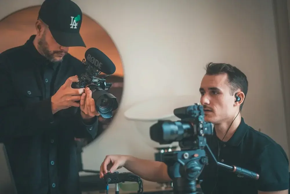 Two men filming with cameras