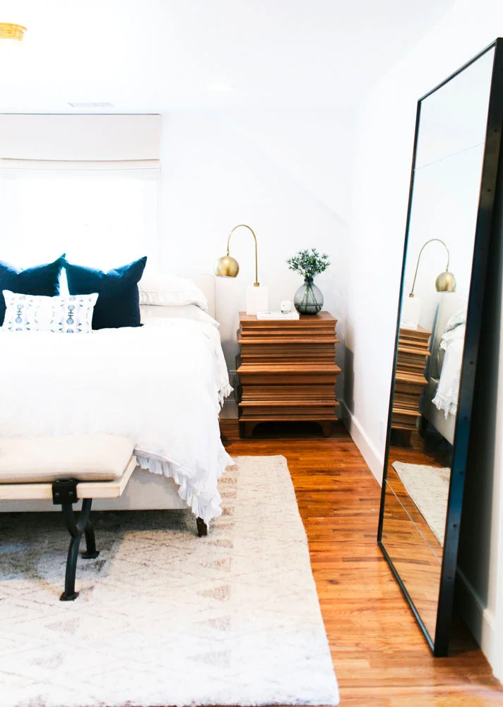 IN THIS DESIGN BY STUDIO MCGEE , AN OVER-SIZED FLOOR MIRROR IS EXACTLY THE KIND OF STATEMENT THIS WALL NEEDED!