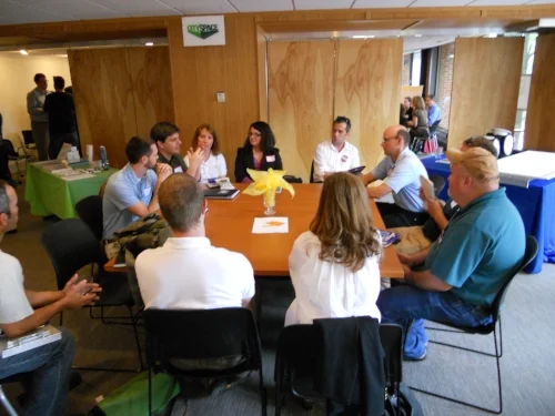 Challenge participants talking to LED lighting expert