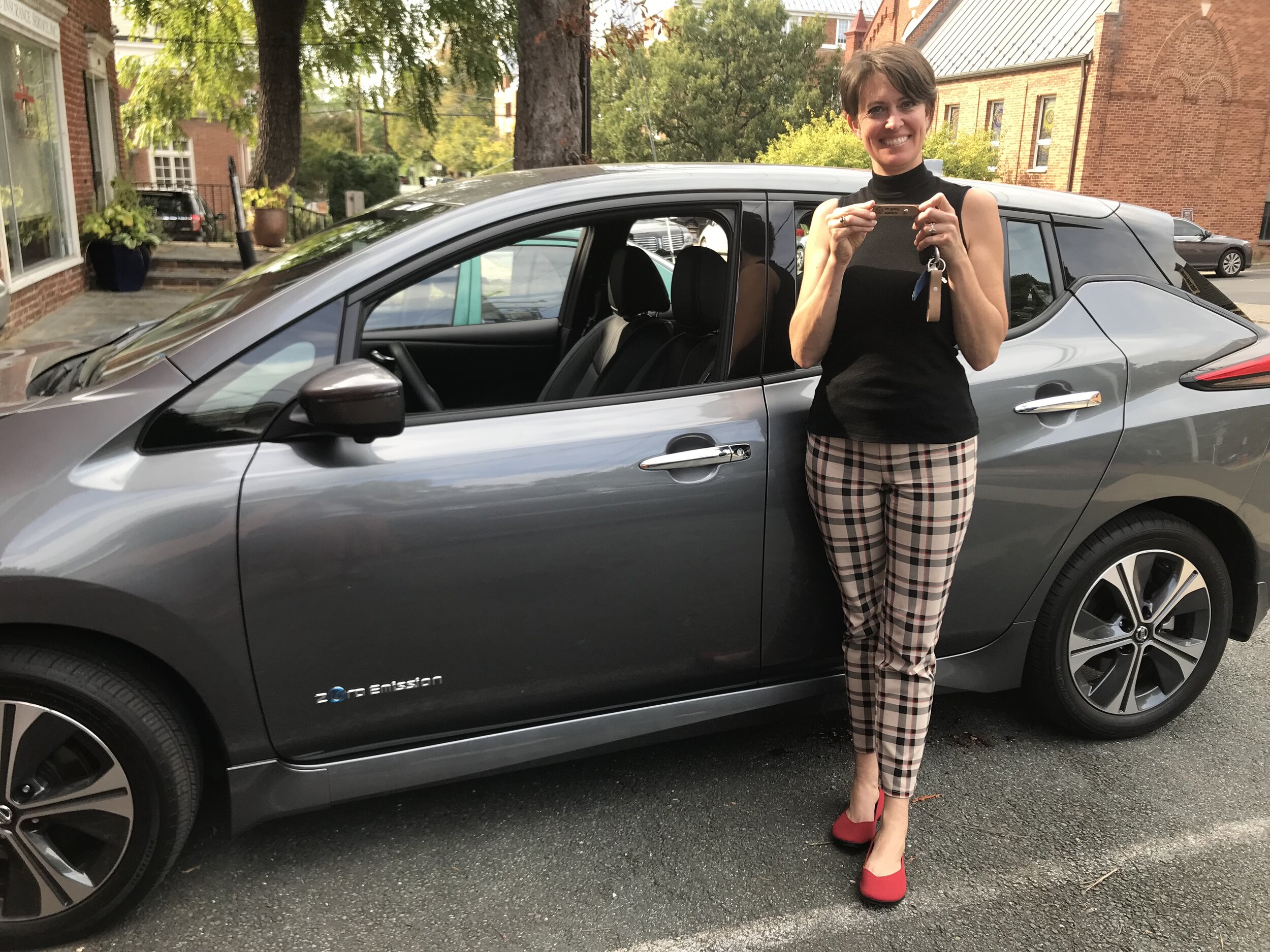 Teri next to Nissan Leaf.JPG