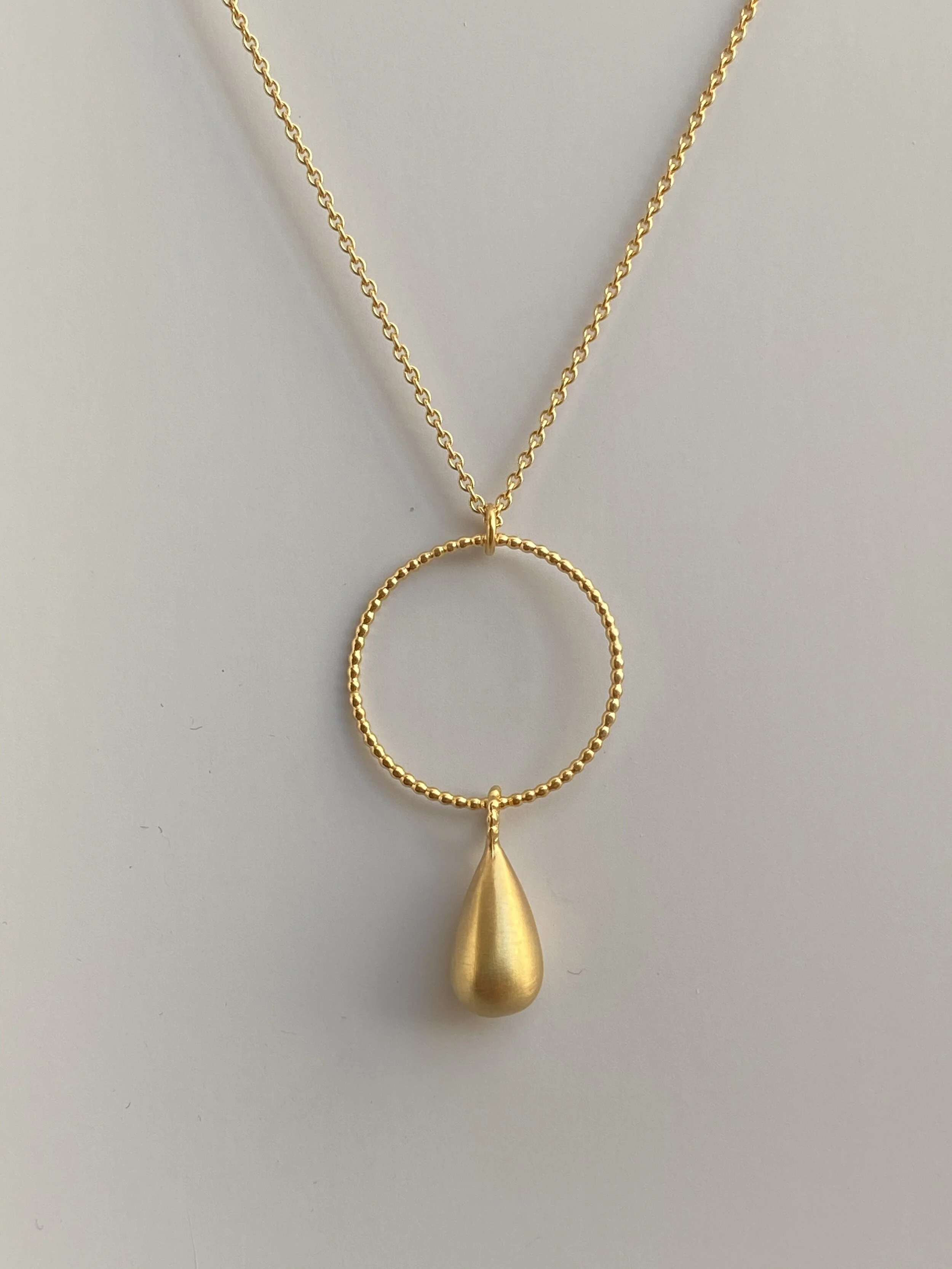 matte gold teardrop with granulated circle