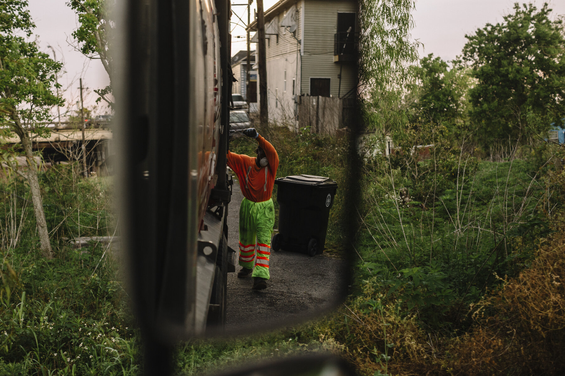  New Orleans, LA - March 24, 2020 - Bryan Bowman wipes sweat from his brown while collecting residential trash in the 7th Ward of New Orleans. His employer, Metro Service Group, has begun furnishing extra rubber gloves, facemasks, and handkerchiefs t