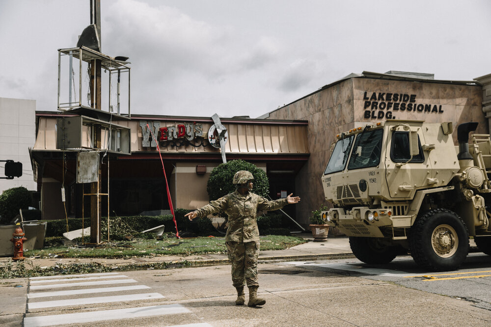  NYTSTORM - Lake Charles, LA - August 27, 2020 - Members of the Army National Guard cleared downed trees and debris from the streets of downtown Lake Charles. Hurricane Laura's high winds and storm surge had a devastating impact on downtown Lake Char