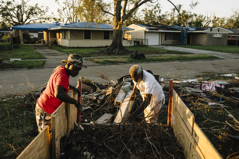  NYTSTORM - Lake Charles, LA - Oct. 9, 2020 - Frank Harrison (L) and Dave Dixon empty a load of debris that they collected from nearby lots. The two men traveled from Miami to volunteer in relief efforts after Hurricane Laura. Lake Charles was hit ha