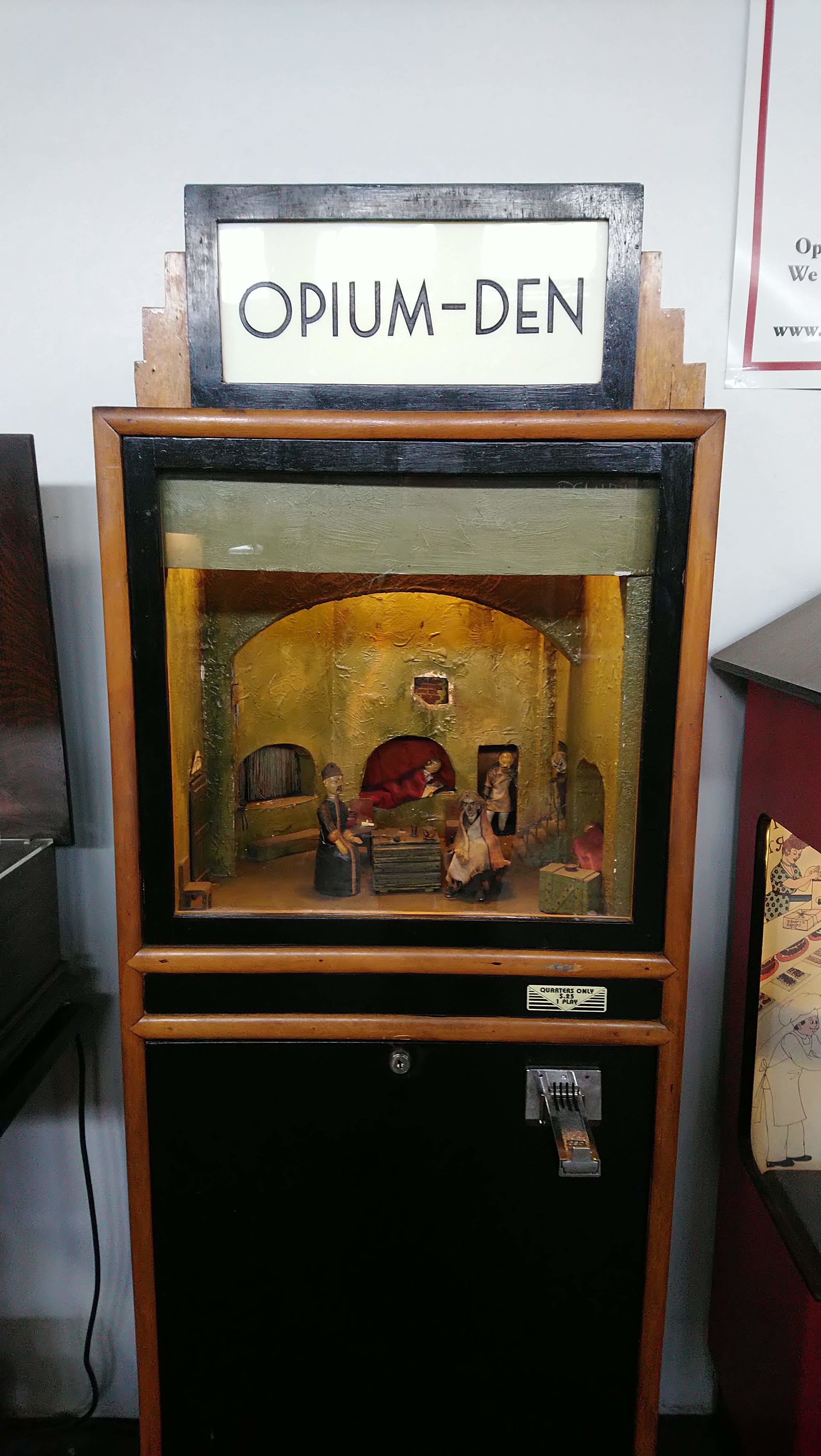 When you feed a quarter into this the guys sort of wobble around a bit, then the chest in the middle opens and there’s a guy inside. I think he’s meant to be dead.