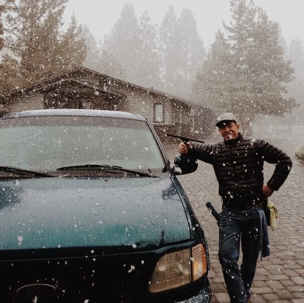 Sunshine Window Cleaning team member Jean Paul cleaning windows in the snow in Bend Oregon