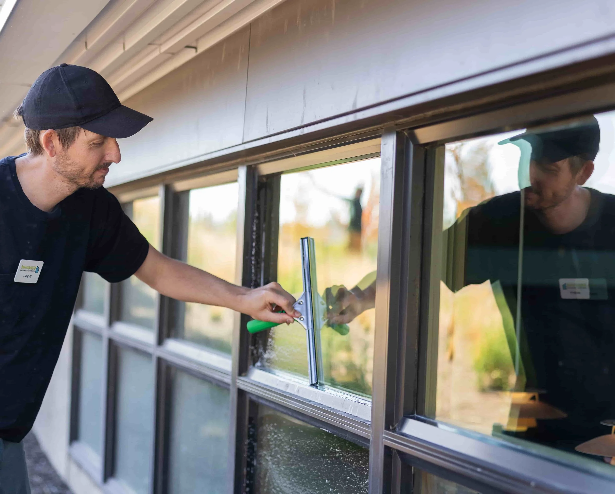 Professional window cleaner servicing a residential home in Bend Oregon