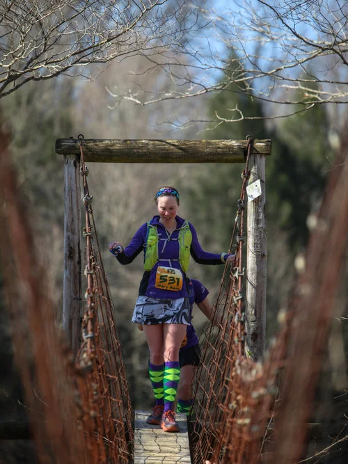 Crossing the foot bridge at 2018 Big Turtle 50