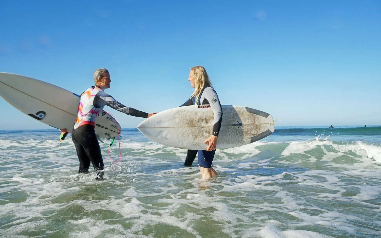 Our Expert Surf Coach Courtney (on the right) congratulating Deb for an awesome surf session!