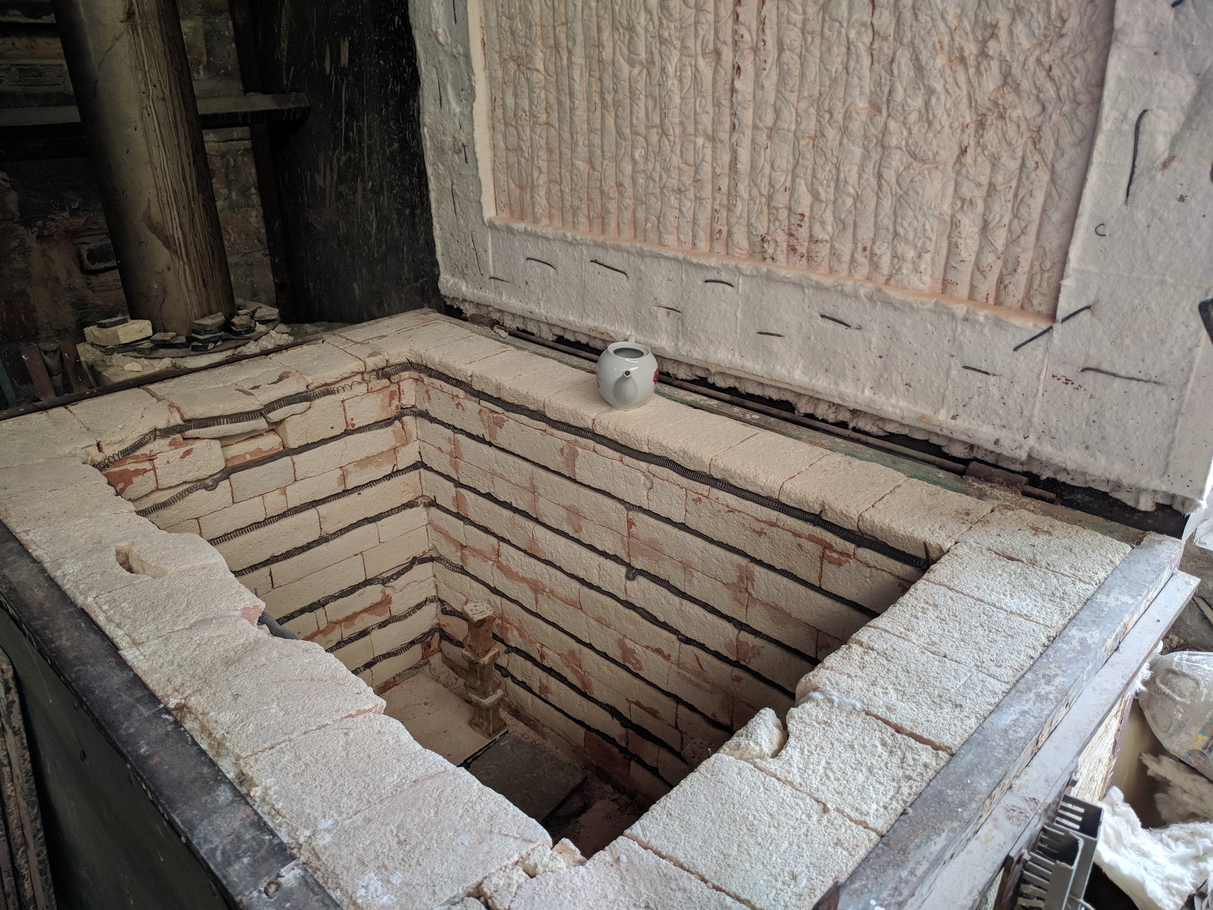 Pieces are finished in this small kiln...